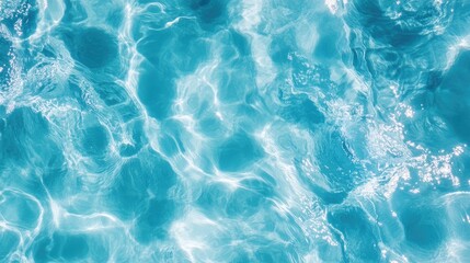 Obraz premium Close-up of crystal-clear blue water, highlighting the textures and movement of the waves, ideal for a refreshing summer vibe.