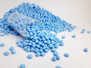Serene sky blue masterbatch granules on white background. Color pigment carrier polymer in plastic...