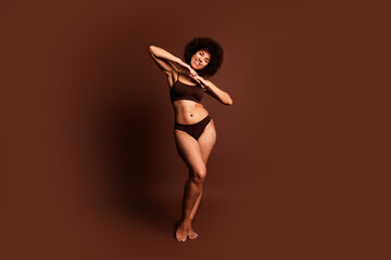 Full length photo of dreamy shiny lady underwear lingerie loving her imperfections emtpy space isolated brown color background