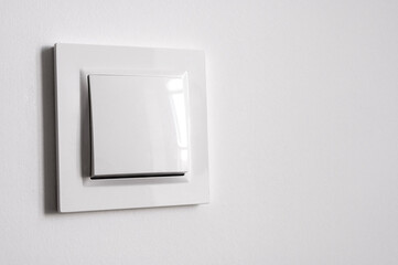 White power switch on white wall