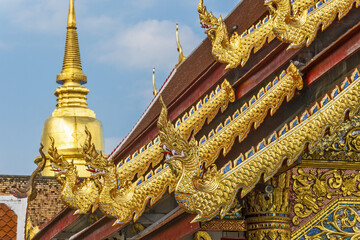 Viharn Luang and the golden dome of Chedi Phrathatluang in the Wat Phra Singh Temple in Chiang Mai,...