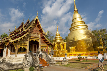 Naklejka premium Wihan Lai Kham temple and the Chedi Phrathatluang in the Wat Phra Singh Temple in Chiang Mai, Thailand 