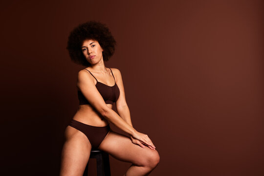 Photo of adorable shiny lady underwear lingerie enjoying self acceptance emtpy space isolated brown color background