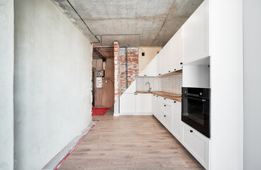 Photo collage of old apartment and new renovated room with parquet floor, kitchen counter, stove and white kitchen furniture. Concept of home renovation, restoration and refurbishment.