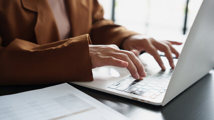 Mature business asian woman entrepreneur in office using laptop. 60s businesswoman with technology asian senior woman