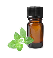 Essential oil in bottle and oregano leaves isolated on white