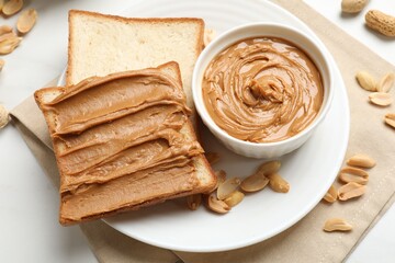 Delicious sandwich with peanut butter and fresh nuts on table, above view
