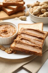 Delicious sandwich with peanut butter and fresh nuts on table, closeup