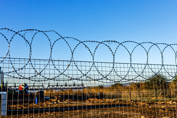 Sharp razor wire on fence around construction site