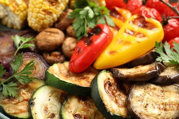 Delicious grilled vegetables and spices on table, closeup