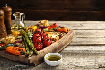 Delicious grilled vegetables with spices on wooden table, closeup. Space for text