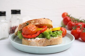Tasty sandwich with grilled vegetables and cream cheese on white table, closeup