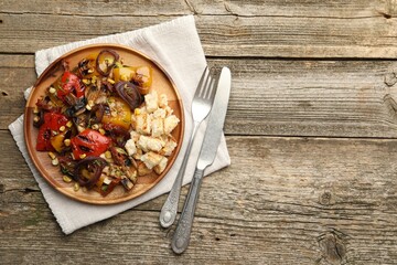 Delicious salad with grilled vegetables served on wooden table, flat lay. Space for text
