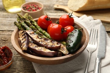 Delicious grilled vegetables served on wooden table, closeup