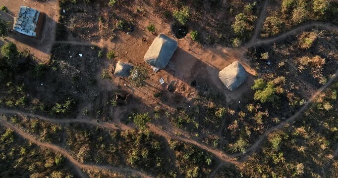 Cinematic drone shot rising above small Zambia village