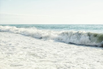 Obraz premium Big waves in the sea. Beautiful sea with splashes under the bright morning sunlight.