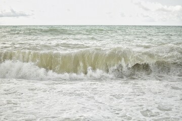 Big waves in the sea. Beautiful sea with splashes under the bright morning sunlight.