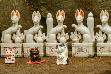 Kyoto, Japan - 4th March 2018 - ceramic fox and cat figurines at Nonomiya Shrine surrounded by Arashiyama Bamboo Grove