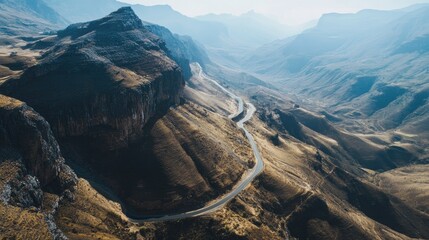 Overhead shot of a mountain pass with winding roads, clear sky for adding text