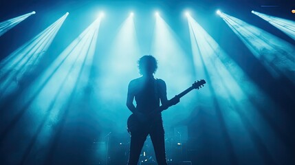 Obraz premium Bright concert stage lights creating a silhouette effect of the lead guitarist, energetic audience