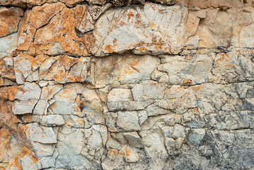 Closeup natural rough stone texture, cracked rock surface background