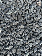 Crushed grey stone on the ground texture background