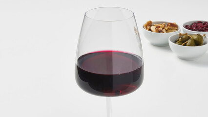 Closeup of a snifter wine glass on a white kitchen counter.