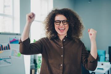 Photo of cheerful lovely charming successful young lady office manager hand fist yes workstation...