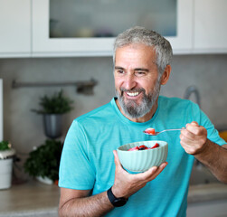 kitchen food man healthy morning mature breakfast active fitness diet home healthy senior adult ...
