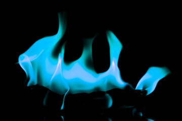 Blurred image of blue flames on a black background.