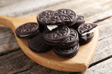 Many tasty sandwich cookies on wooden table