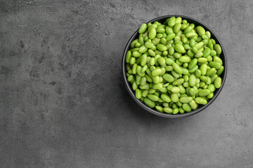 Raw green edamame soybeans on grey table, top view. Space for text