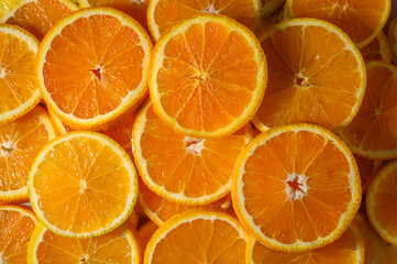 Top view of Orange slices against orange background.