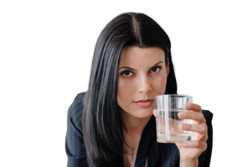 Confident woman in professional attire holding a glass of water, making direct eye contact with the camera. Isolated on a transparent background