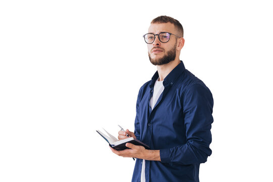 Thoughtful man with glasses writing in a notebook, deep in concentration. Wearing casual attire, he stands isolated on a transparent background