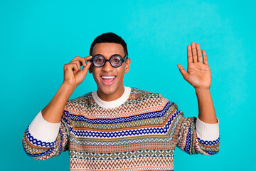 Photo of nice young man touch eyeglasses arm wave wear sweater isolated on teal color background