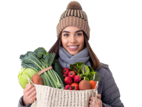 woman in winter cloths holding a bag full of vegetables isolated