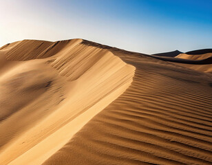 aerial view of  sand dune with ripples between desert with clear blue sky