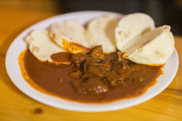 Traditional Czech beef goulash with potato dumplings.