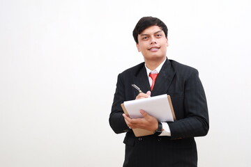 Cheerful young asian businessman posing Holding clipboard with papers document write notes isolated on white background. Mock up copy space.