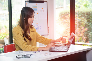 Businesswoman hand writing with tax document at work office