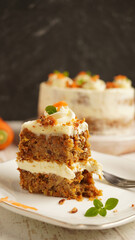 Half eaten gluten free sliced carrot cake on a white saucer over white background. Selective focus. Close up