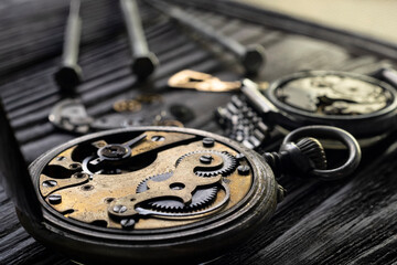 Fototapeta premium Mechanical watch repair with special tools, watchmaker's workshop