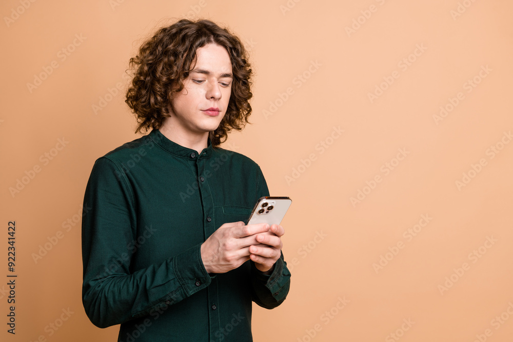 Sticker photo portrait of handsome young guy hold device dressed stylish green garment isolated on beige col