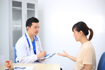 Male doctor with experience examining young pregnant women