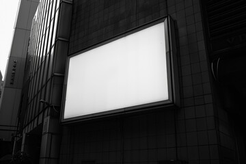 Two tall, vacant billboards lining the side of a building. Urban setting with potential advertising spaces.