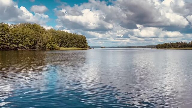 Movement of water against the background of the sky and green forest