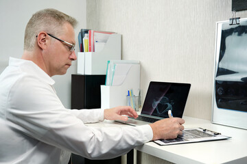 A radiologist interprets patient examination results.