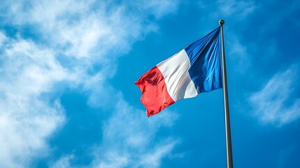 Majestic French Flag Waving Against Serene Blue Sky with Gentle Clouds