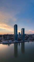 Modern City by river at sunset twilight. New Westminster, Vancouver, BC, Canada.